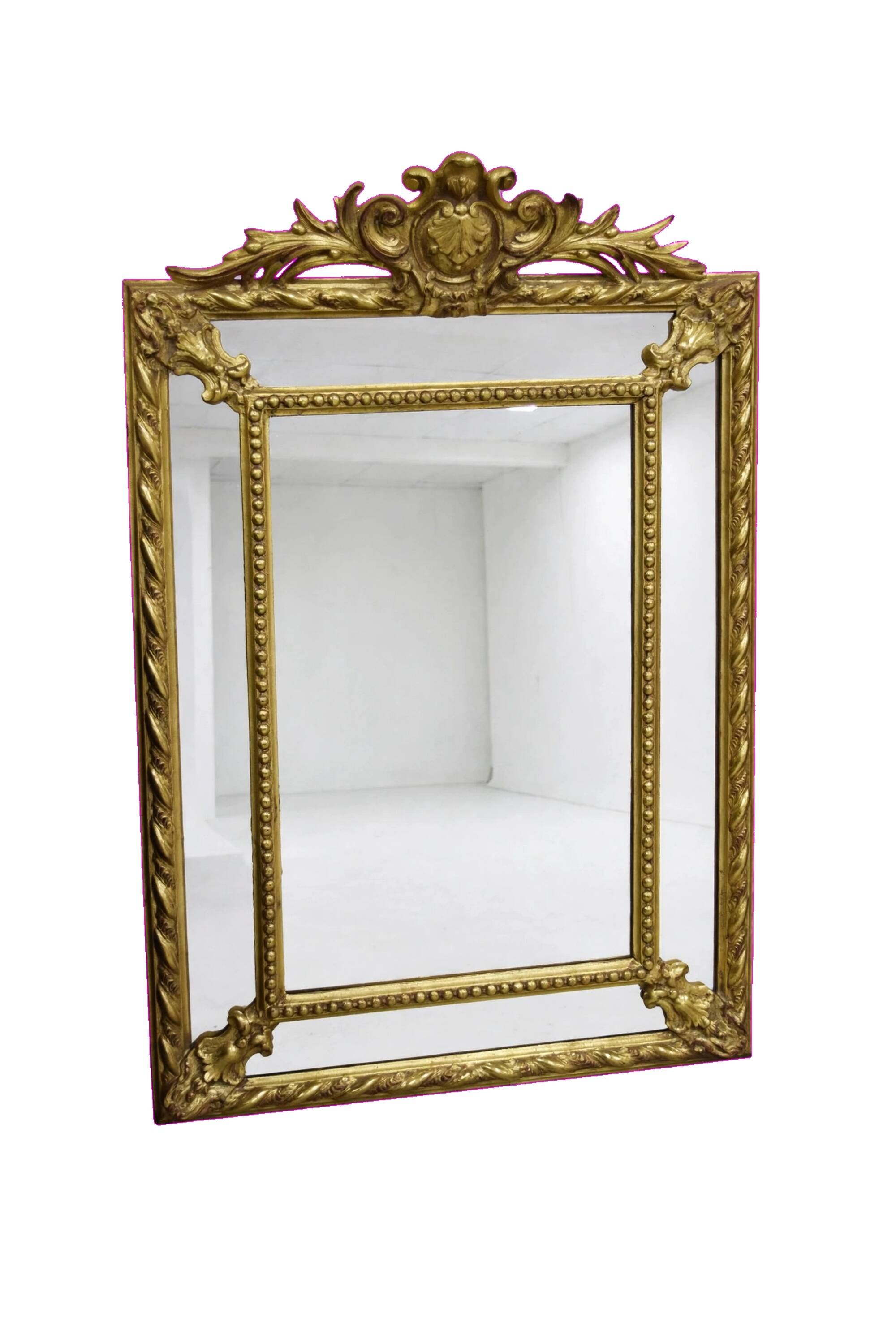 Rectangular glass with a golden frame and a pediment adorned with laurel branches.