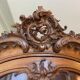 Large wooden display cabinet in Louis XV/rococo style with a strongly curved front.