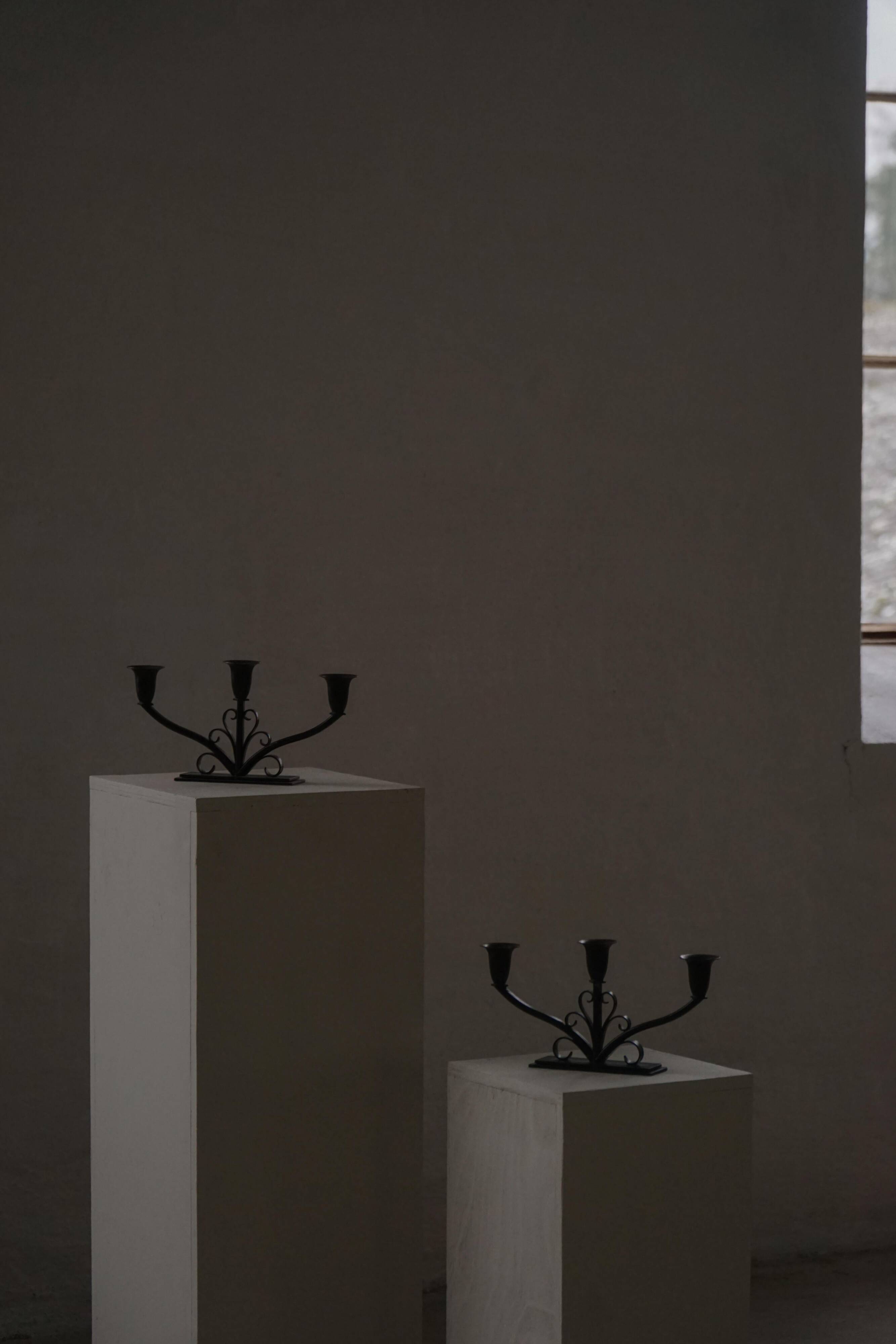 Early 20th century, pair of Danish Art Deco candlesticks in metal with three arms, 1930s.
