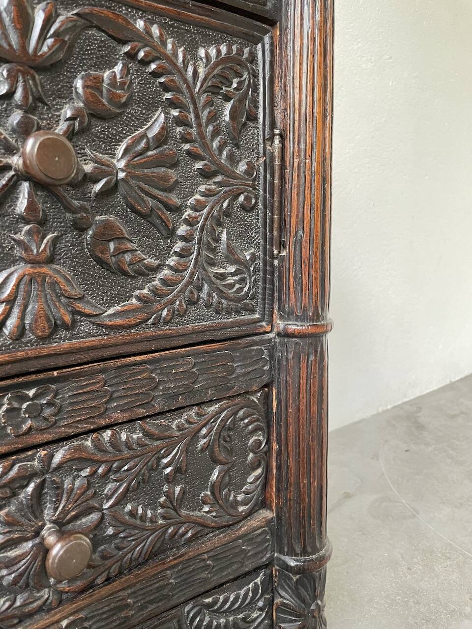 19th century chest of drawers in carved blackened pine
