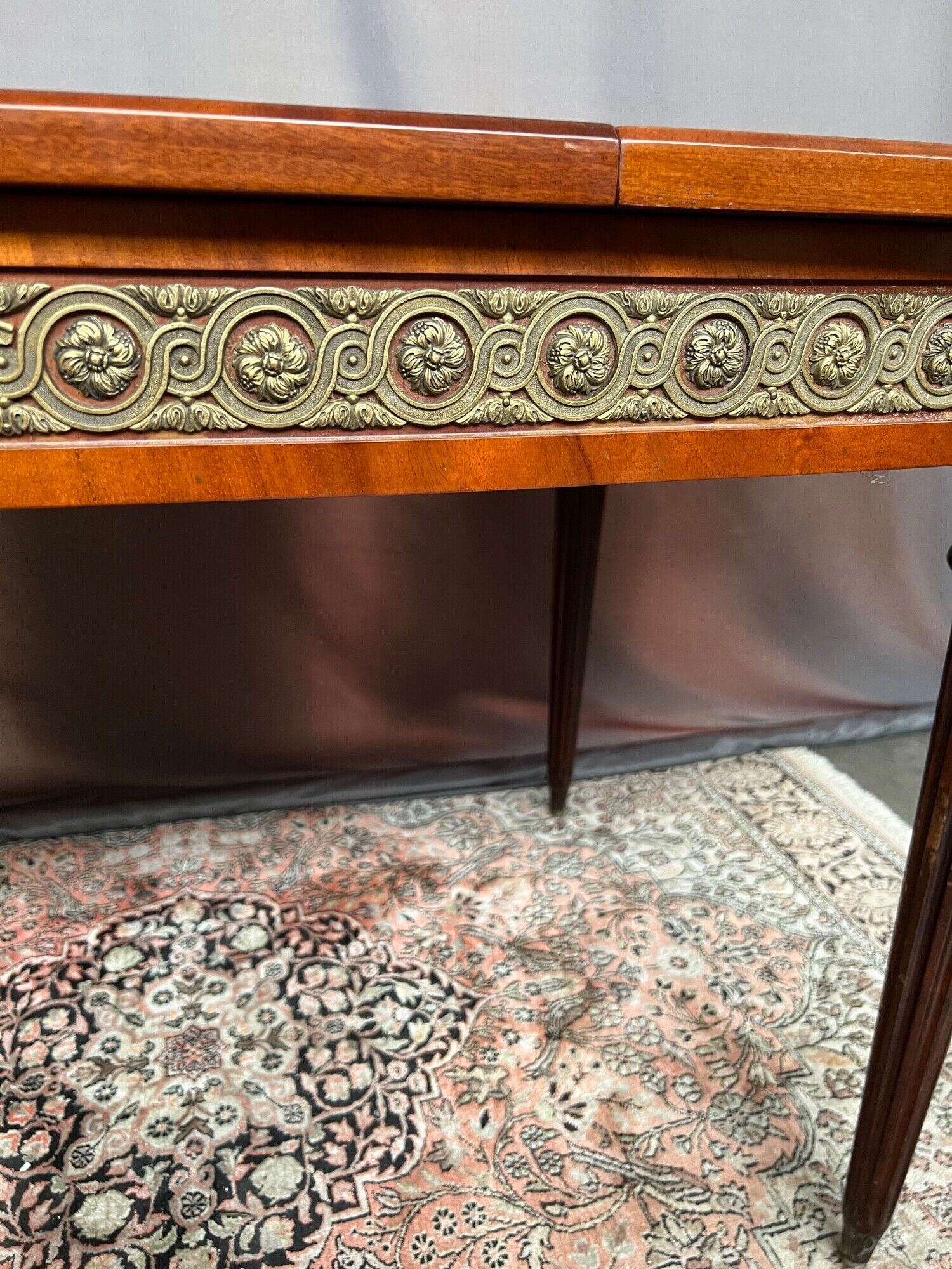 Louis XVI style oval dining table with rosewood marquetry extension mounted in bronze