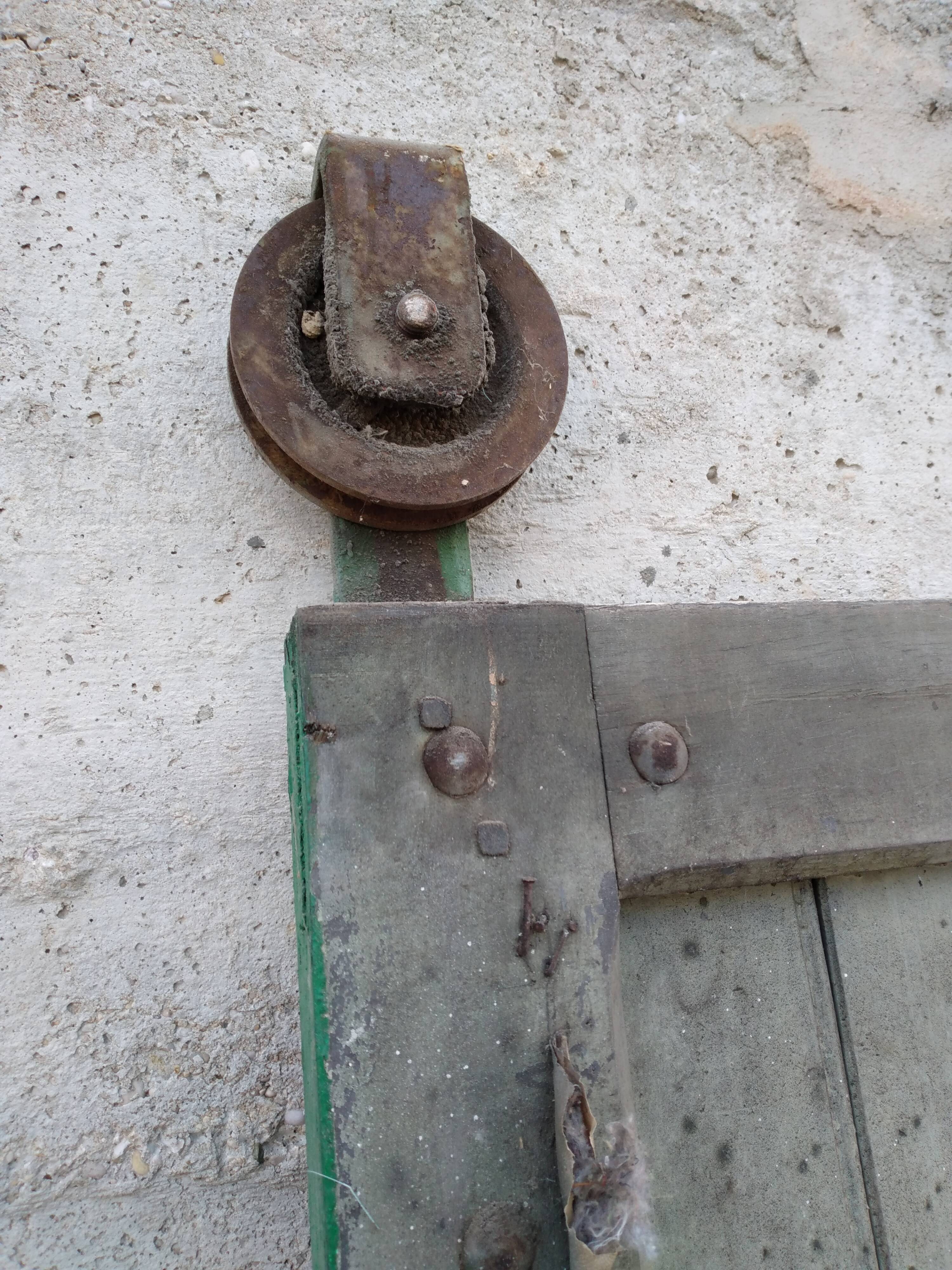 Old wooden door with pulley
