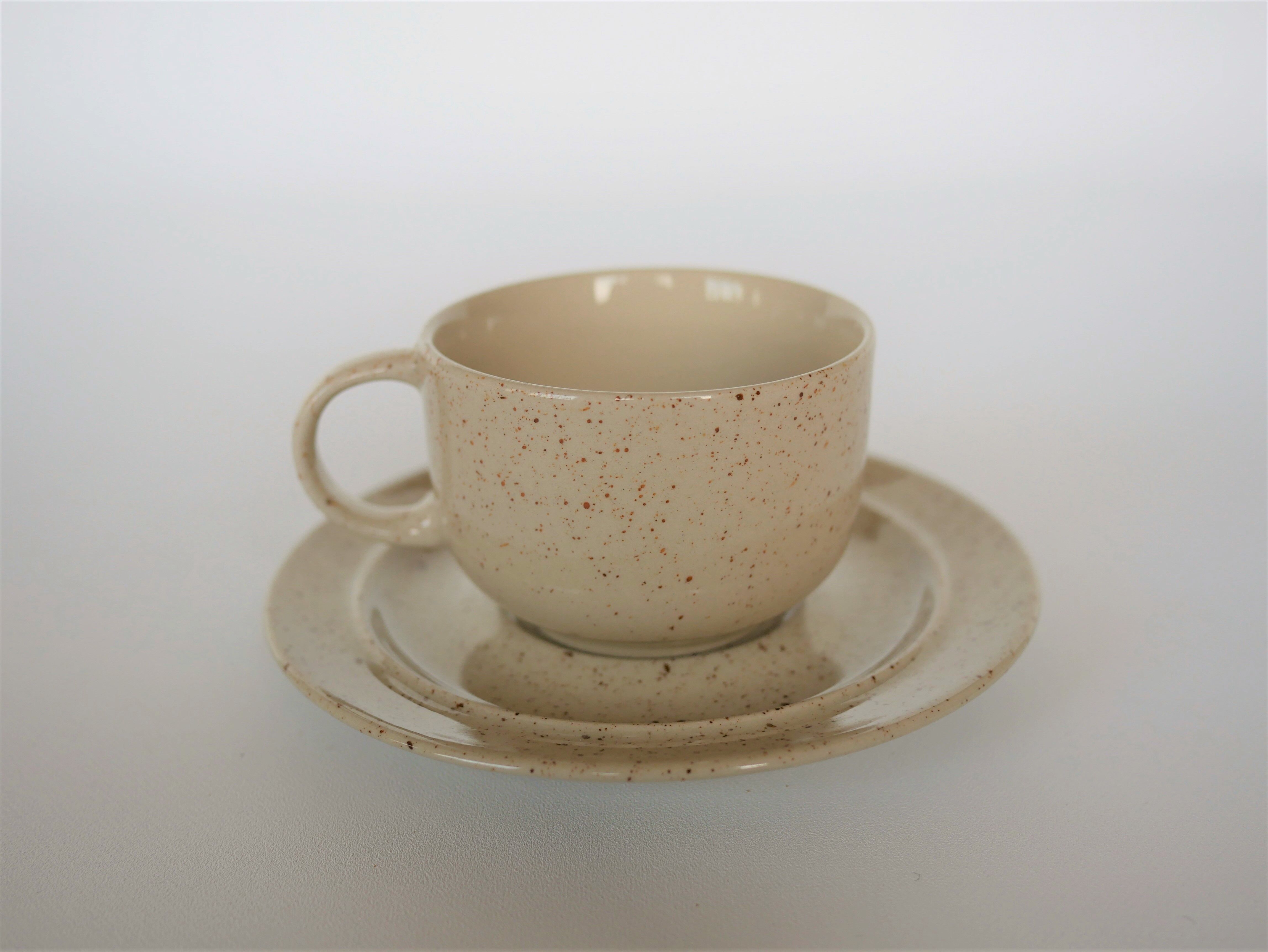 Coffee cup and vintage pyrity sandstone subcup