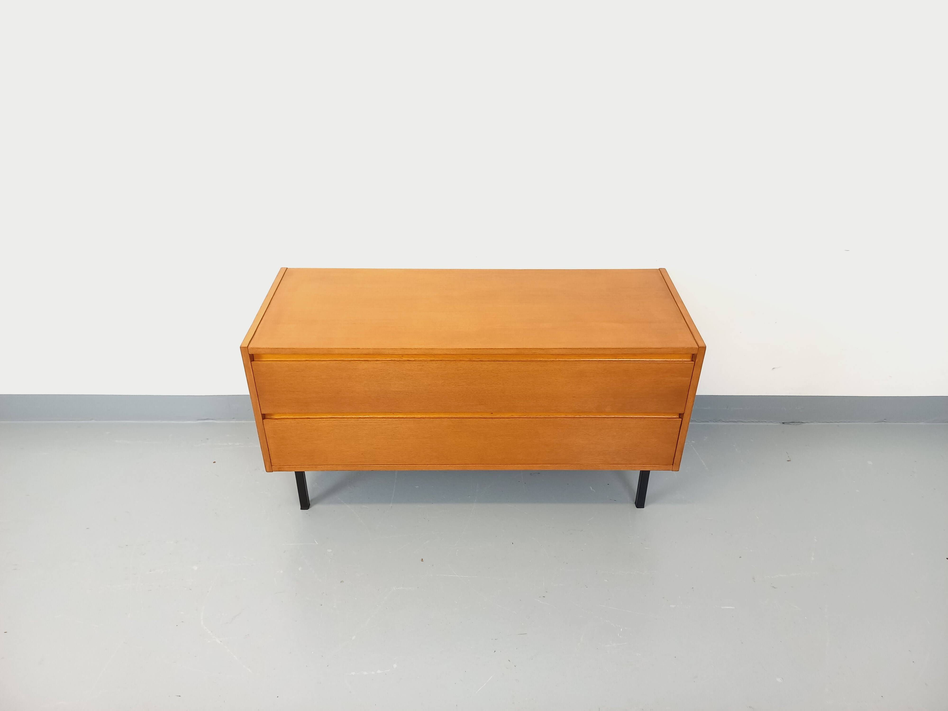 Small vintage Scandinavian sideboard in modernist style made of light oak wood.