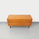 Small vintage Scandinavian sideboard in modernist style made of light oak wood.