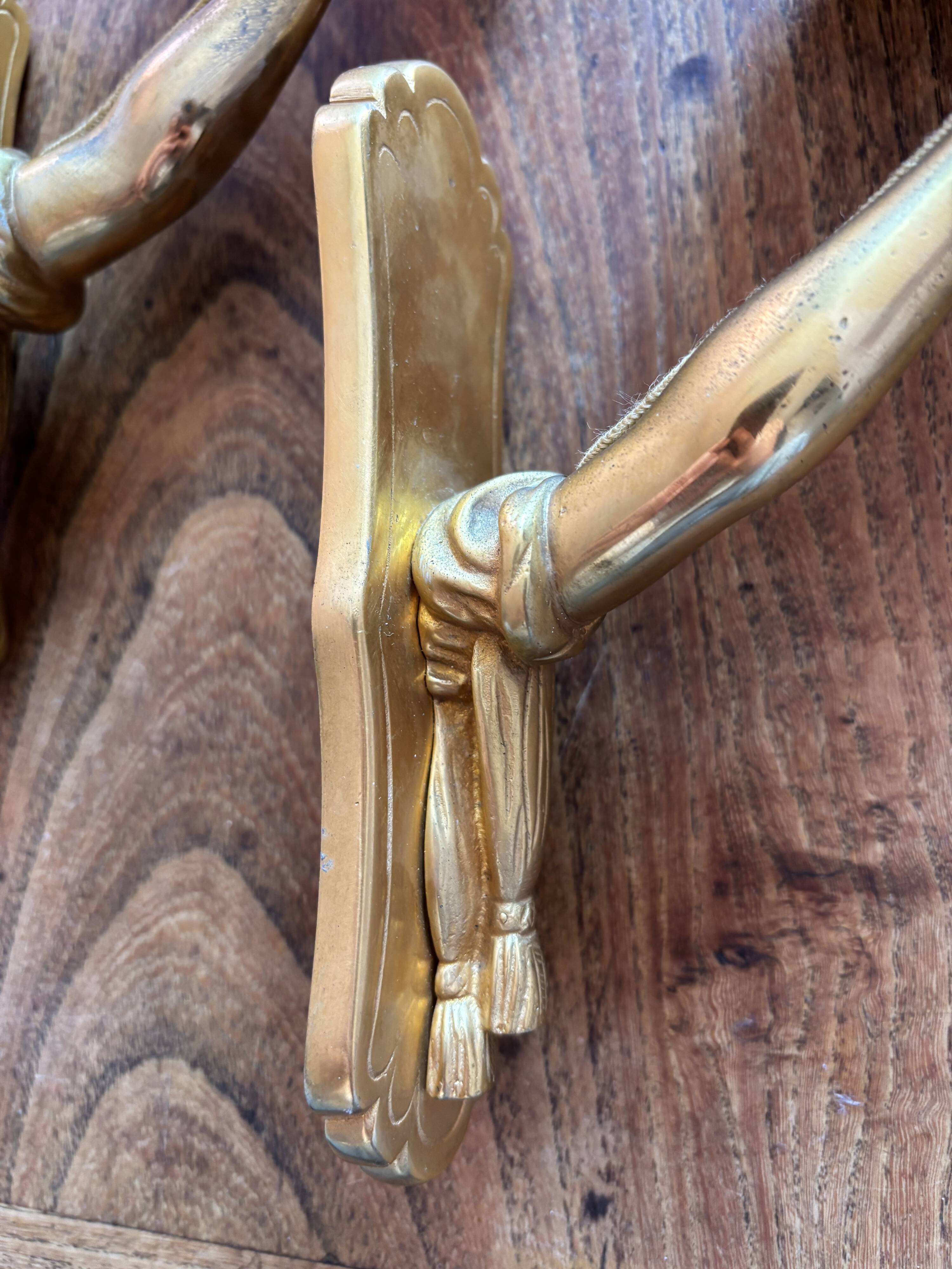 Pair of bronze wall sconces with outstretched arms and hands