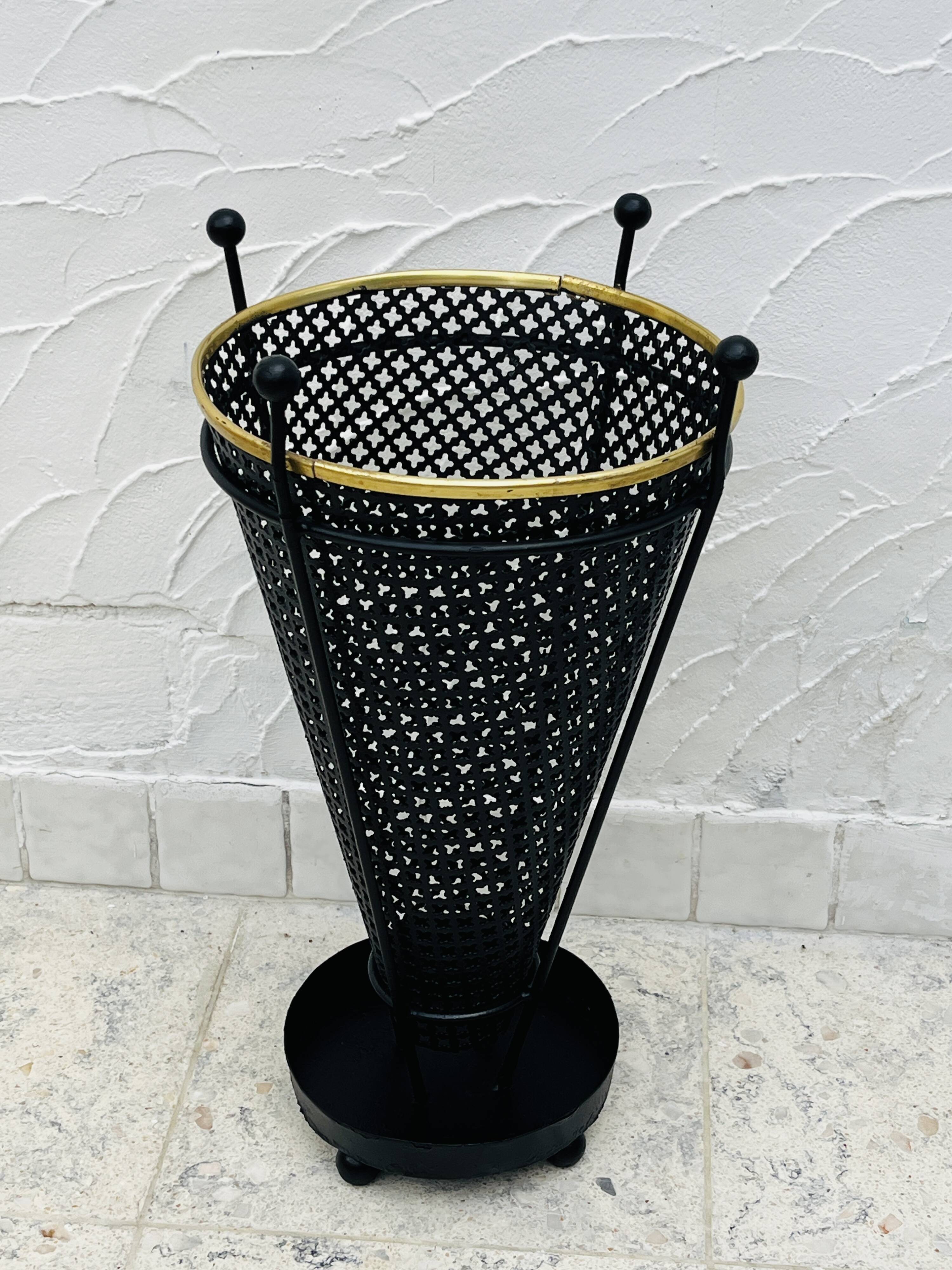 Vintage black perforated metal and brass umbrella stand