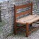 Wooden-backed bench with straw seat, 1970s.