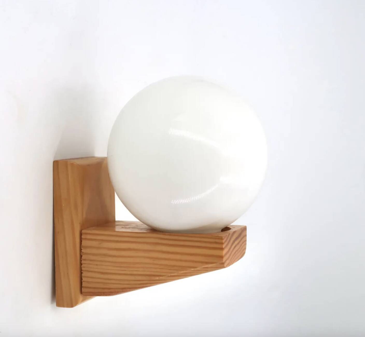 Pine wood wall light with opaque white glass globe, 1980s.