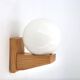 Pine wood wall light with opaque white glass globe, 1980s.