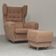 Beige wingback armchair and TVAR footrest, former Czechoslovakia.