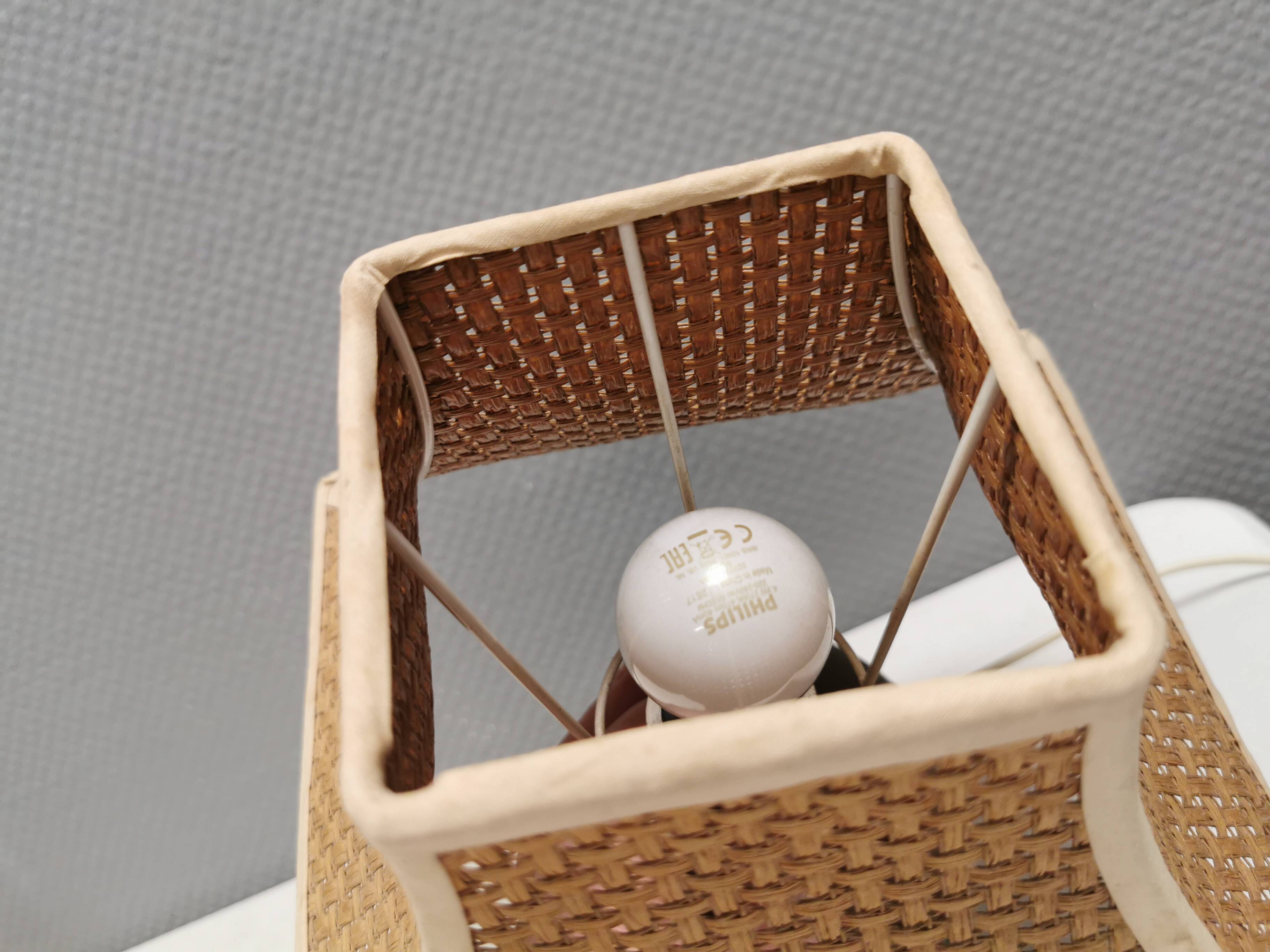 Very rare table lamp in turned teak wood with original braided shade. 1970s
