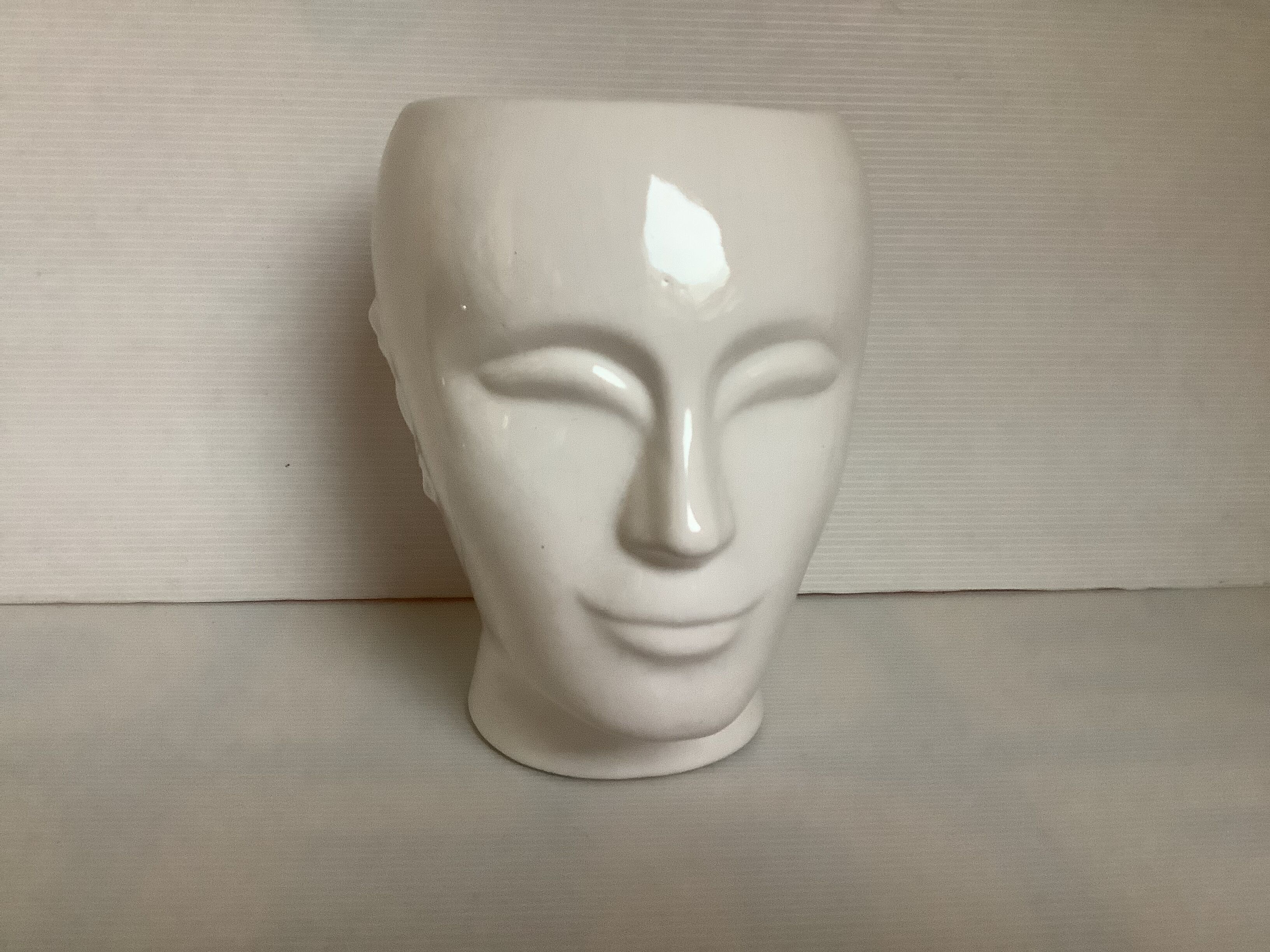 Man's head hide pot vase