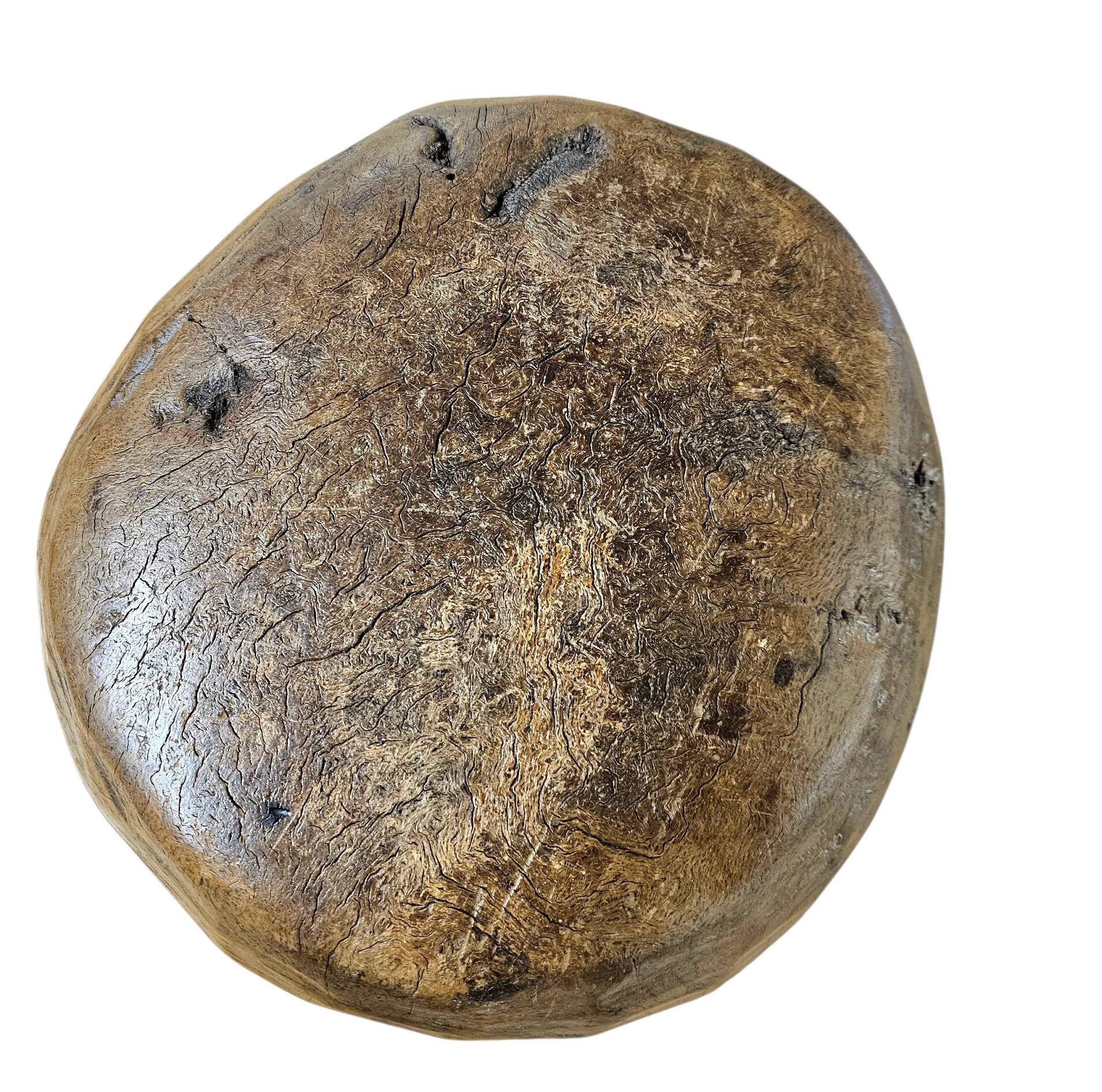 A substantial hand-hewn wooden bowl carved from a single burl section