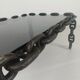 Vintage brutalist black iron chain link coffee table with original smoked glass, 70s