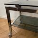 Vintage coffee table on chrome wheel and smoked glass