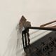 Large antique wall-mounted coat rack in wrought iron.