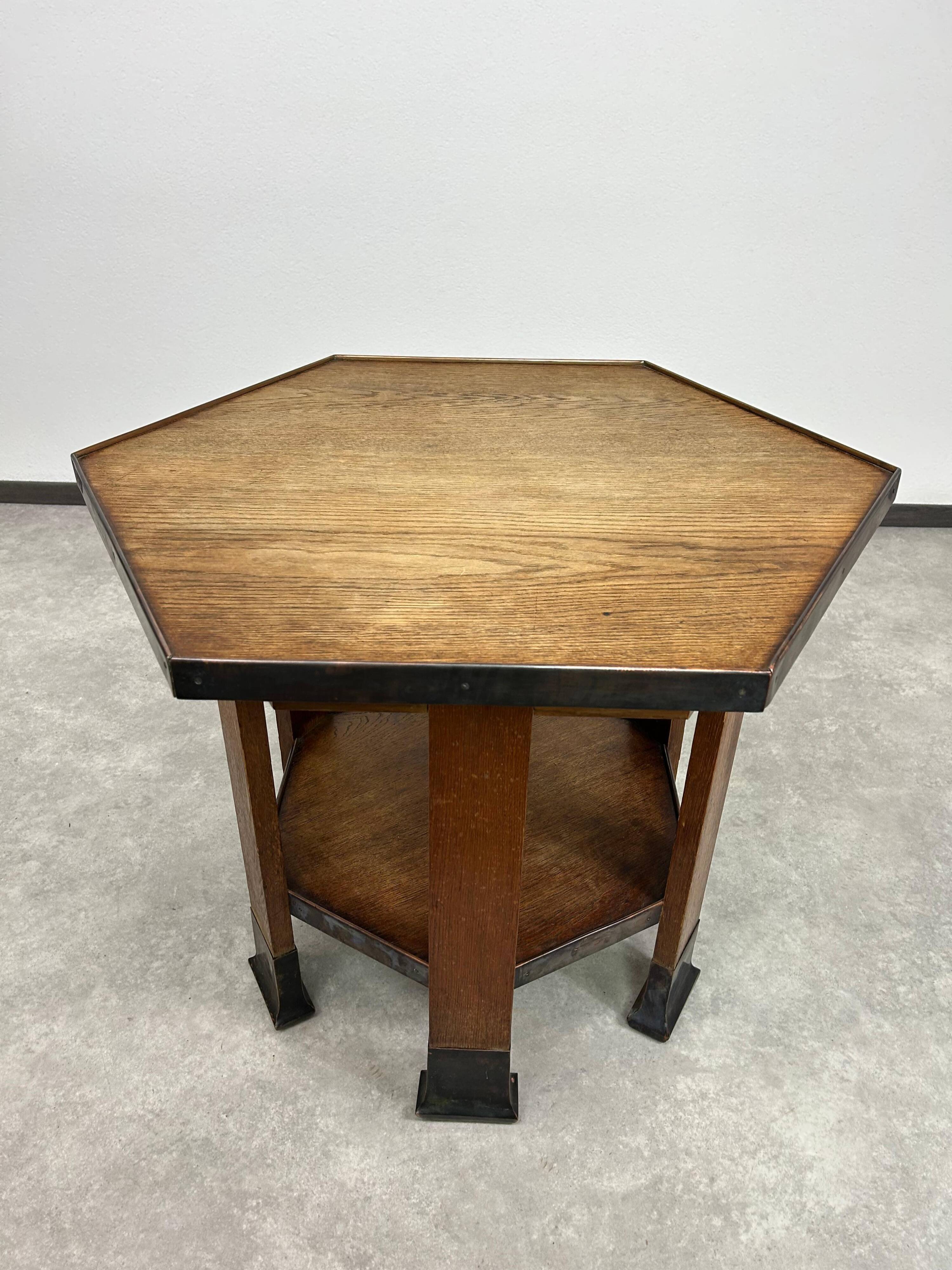 Hexagonal table with six legs in Secession style bordered with brass, attributed to Adolf Loos.