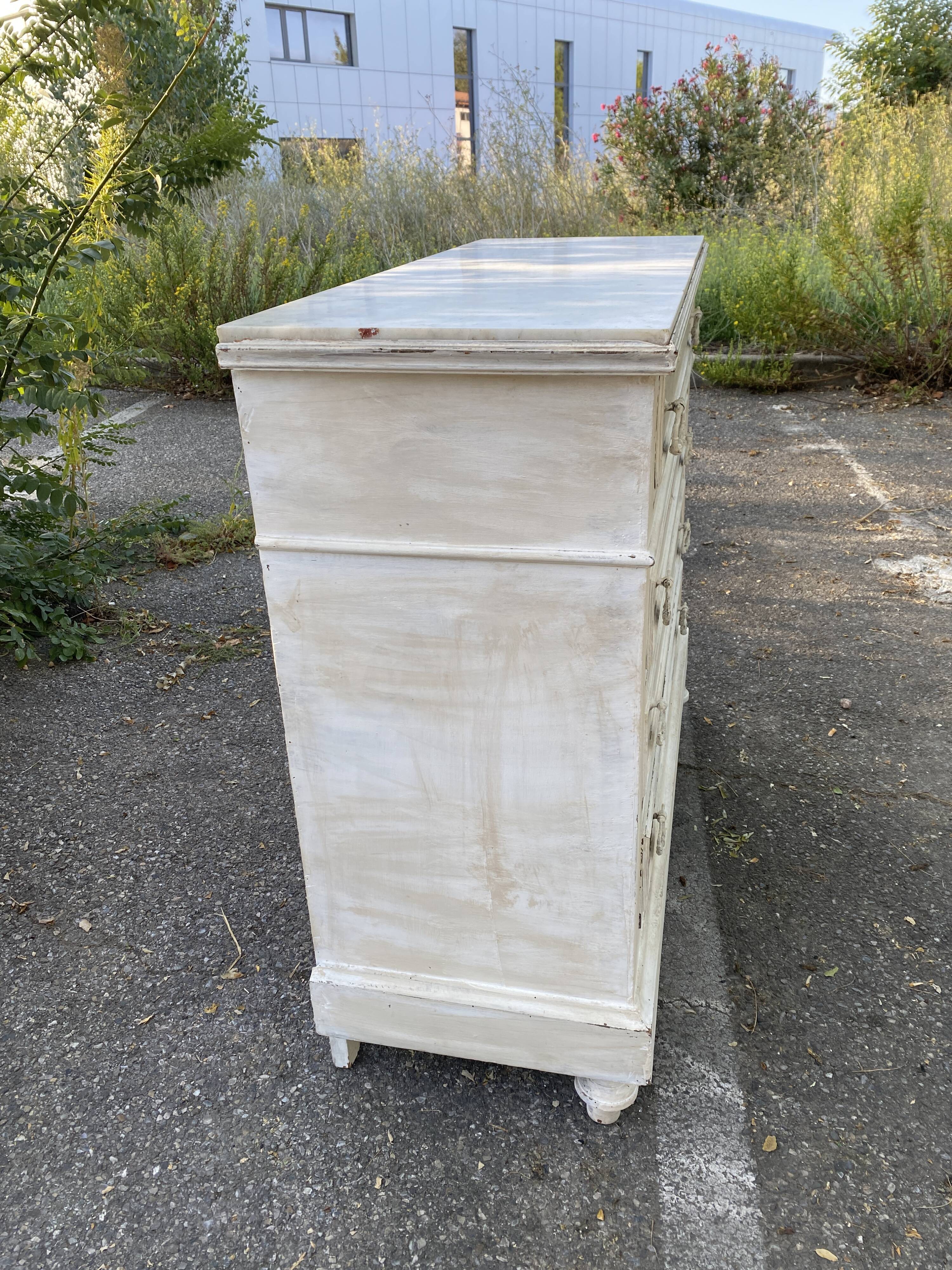 Old chest of drawers in bleached wood with white marble top