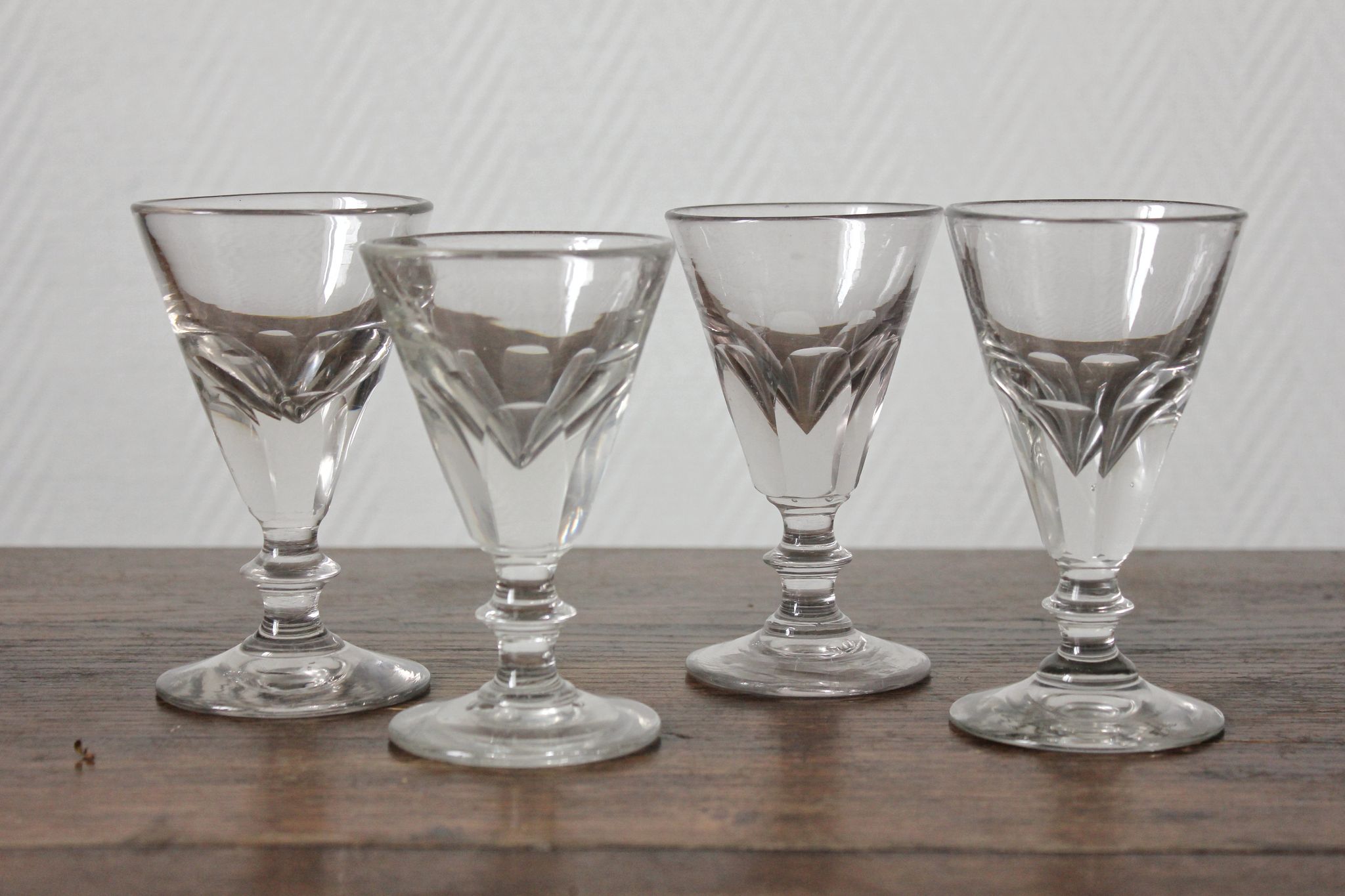 4 antique stemmed wine glasses with flat sides, made of blown glass from the 19th century