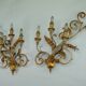 Pair of large floral wall lamps in gilded and lacquered metal. Italy 1960s