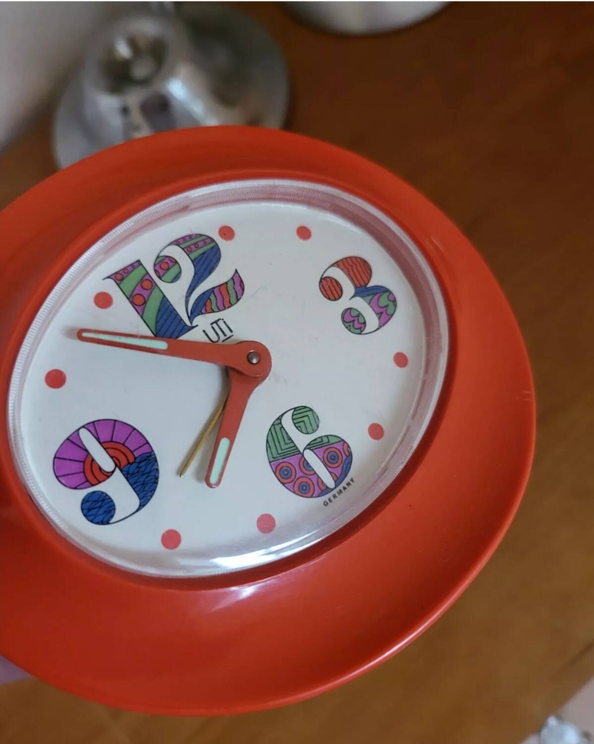 Vintage mechanical alarm clock in orange plastic Uti West Germany