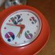 Vintage mechanical alarm clock in orange plastic Uti West Germany