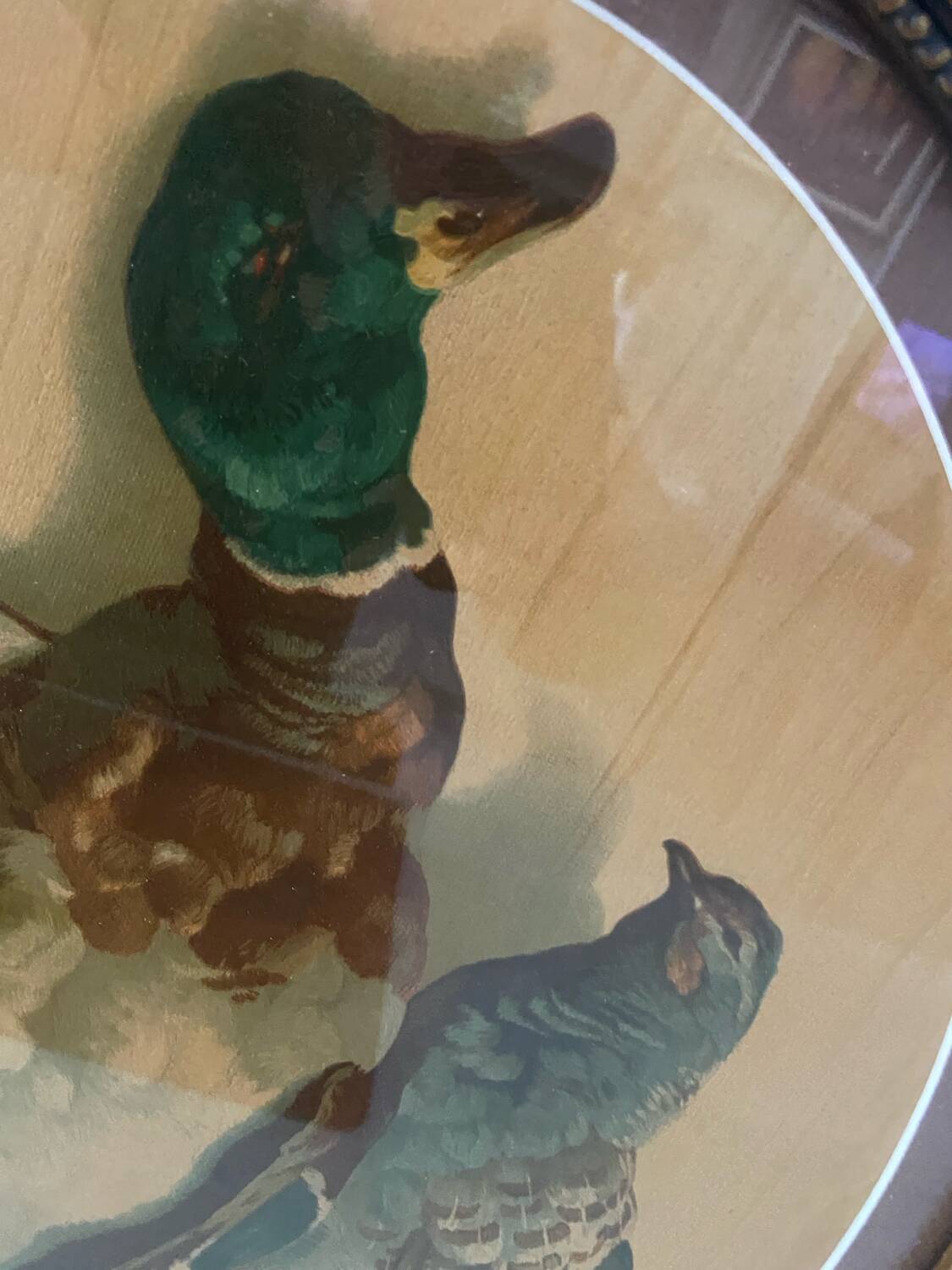 Antique oval frame with an oil painting of green collars