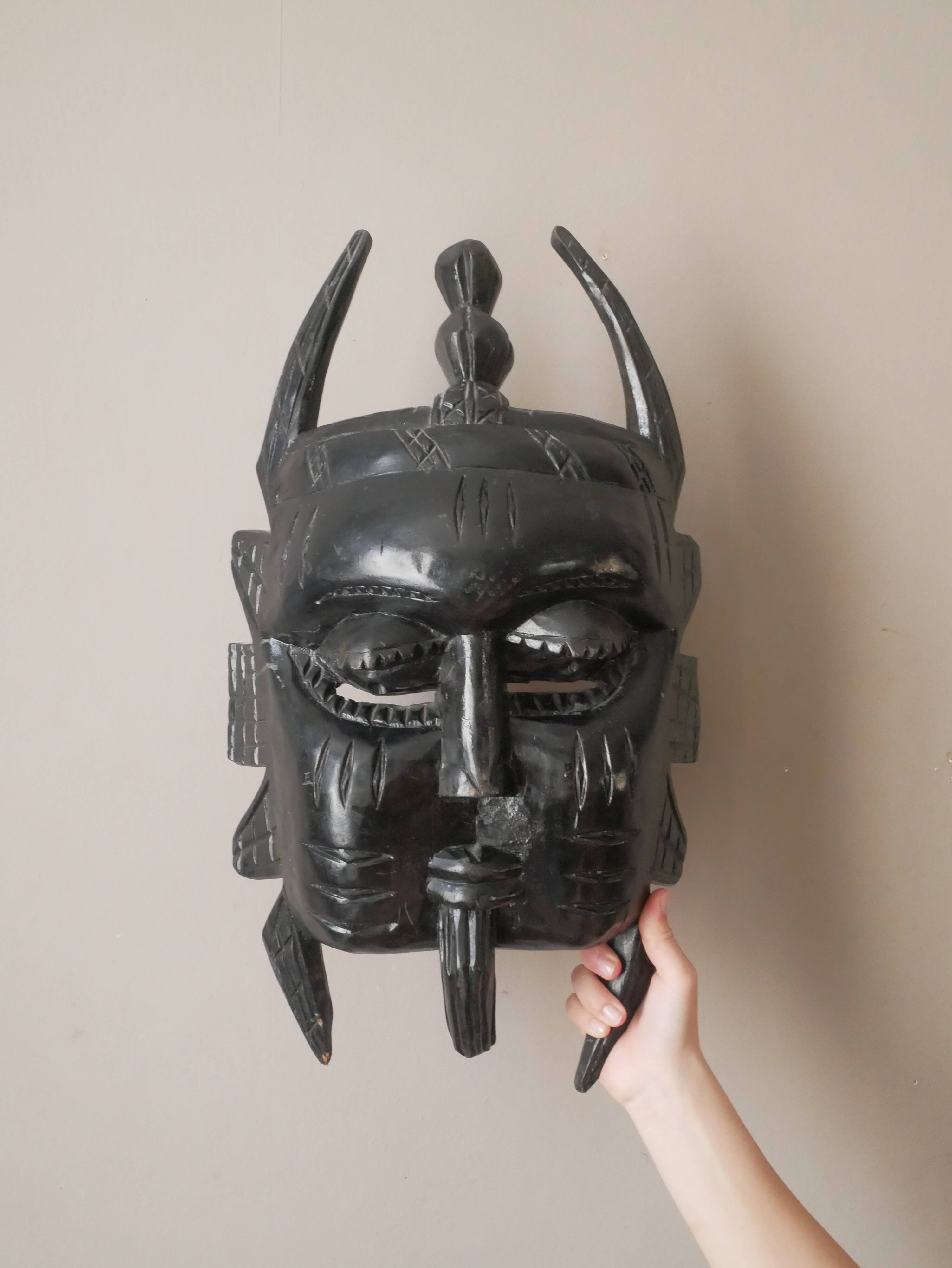 Decorative mask hand carved in tribal ethnic painted wood