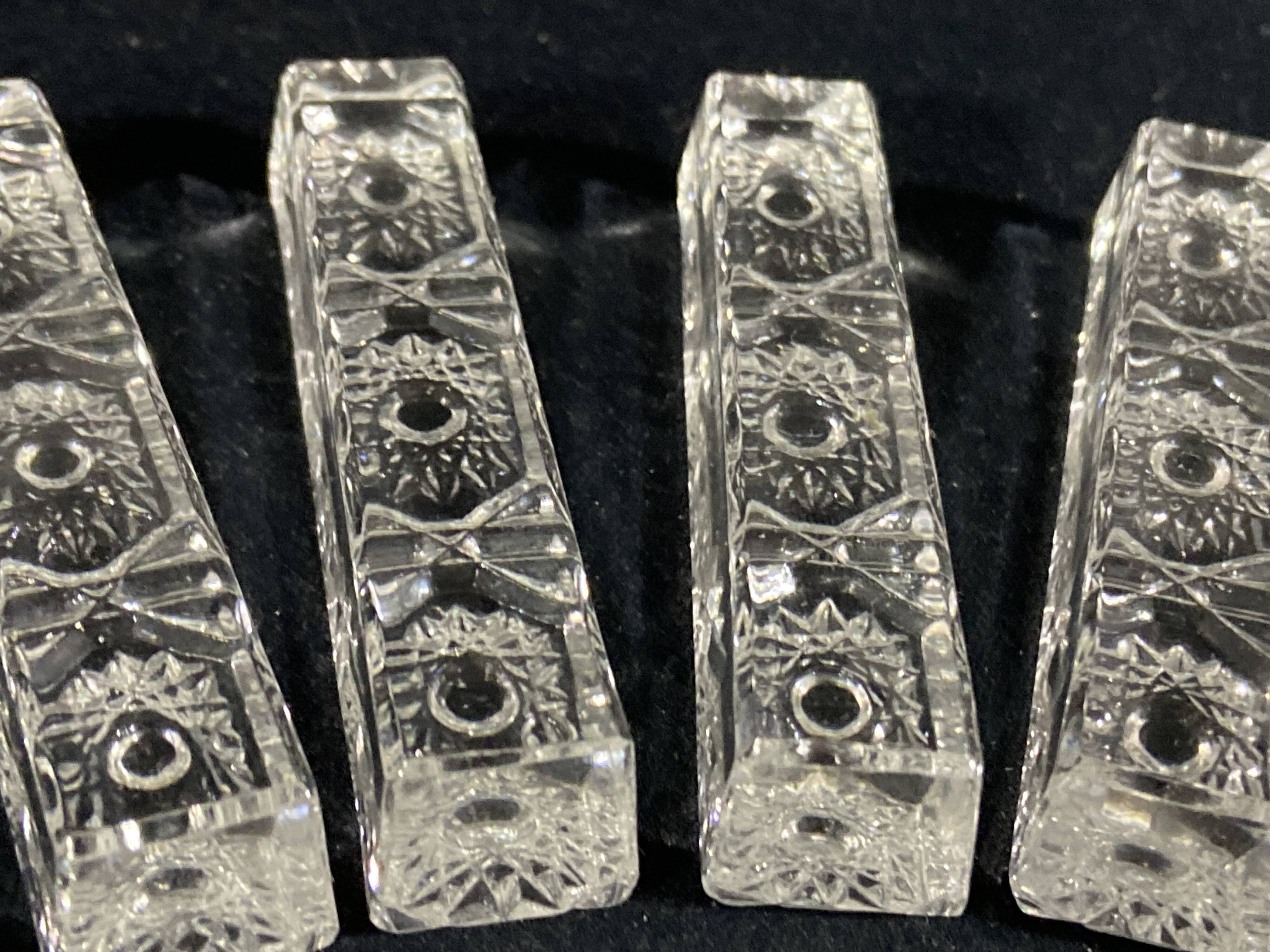 Set of 12 molded glass or crystal knife rests with diamond point decor