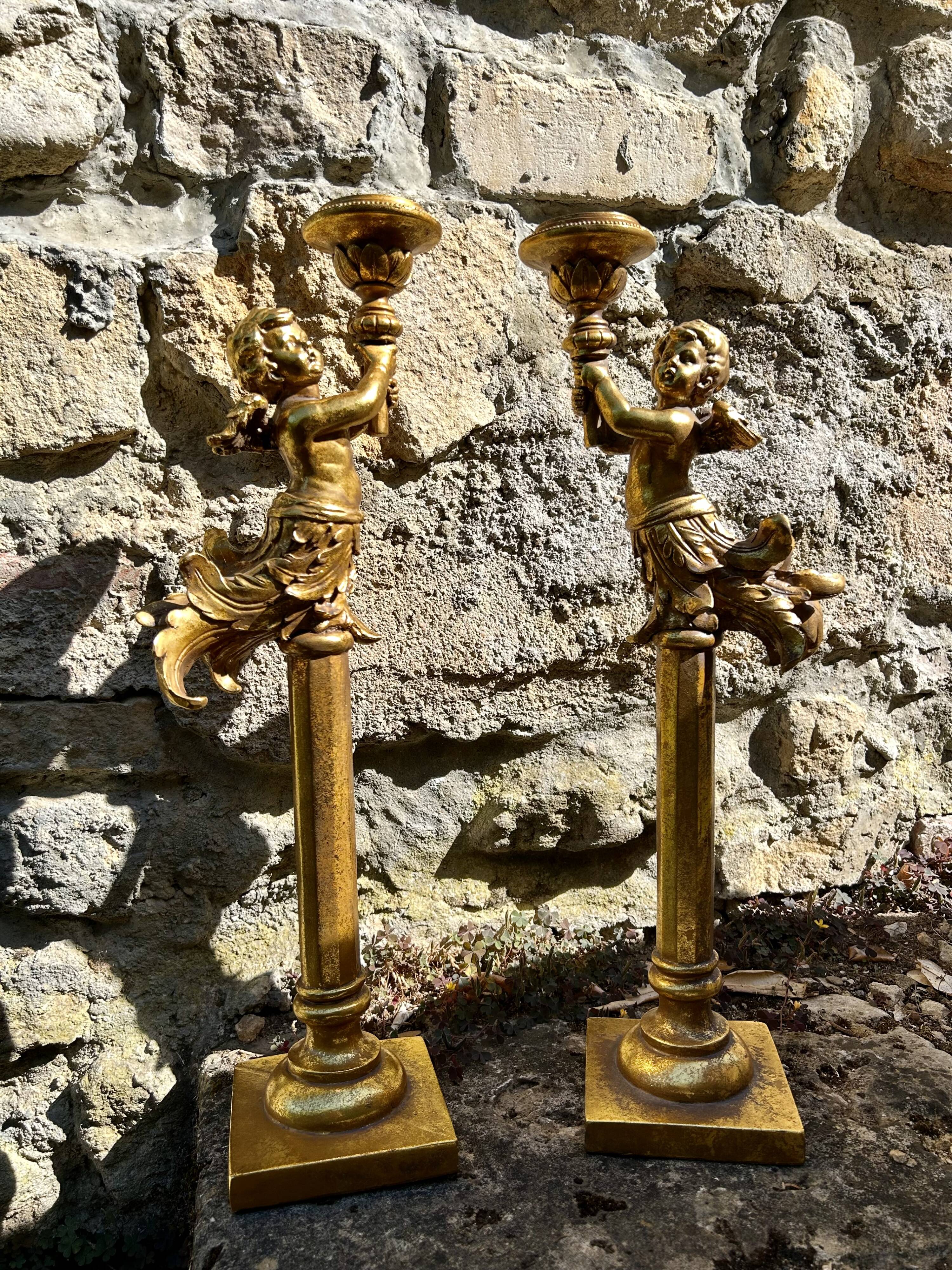 Pair of large candlesticks with cherubs