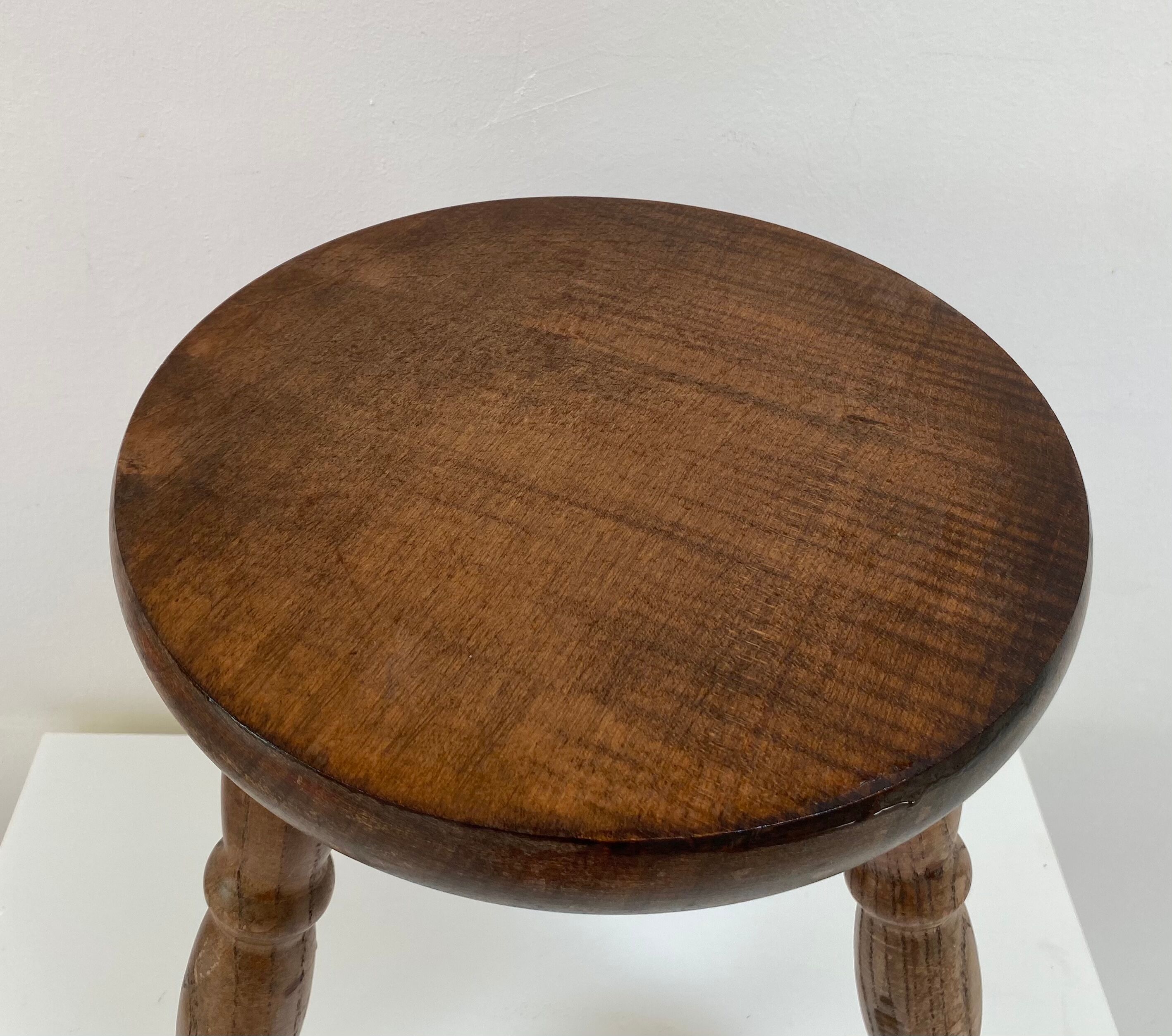 Old wooden tripod stool with ball feet