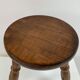 Old wooden tripod stool with ball feet