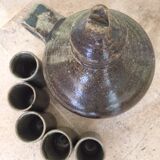 Old liquor service in sandstone, carafe and 5 glasses