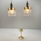 Two gold-plated brass and crystal pendant lights, by Palwa, 1960s design, Hollywood Regency.