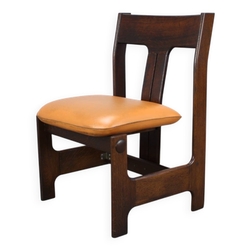 Vintage German sculptural chair from the 1970s in wood with orange faux leather.