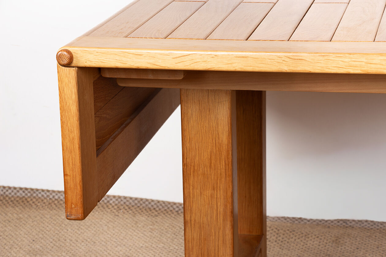 Large extendable dining table in solid oak by Guillerme and Chambron.