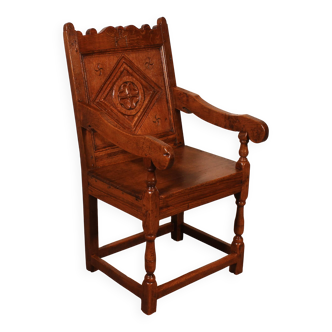 high-backed armchair from the 17th century in oak