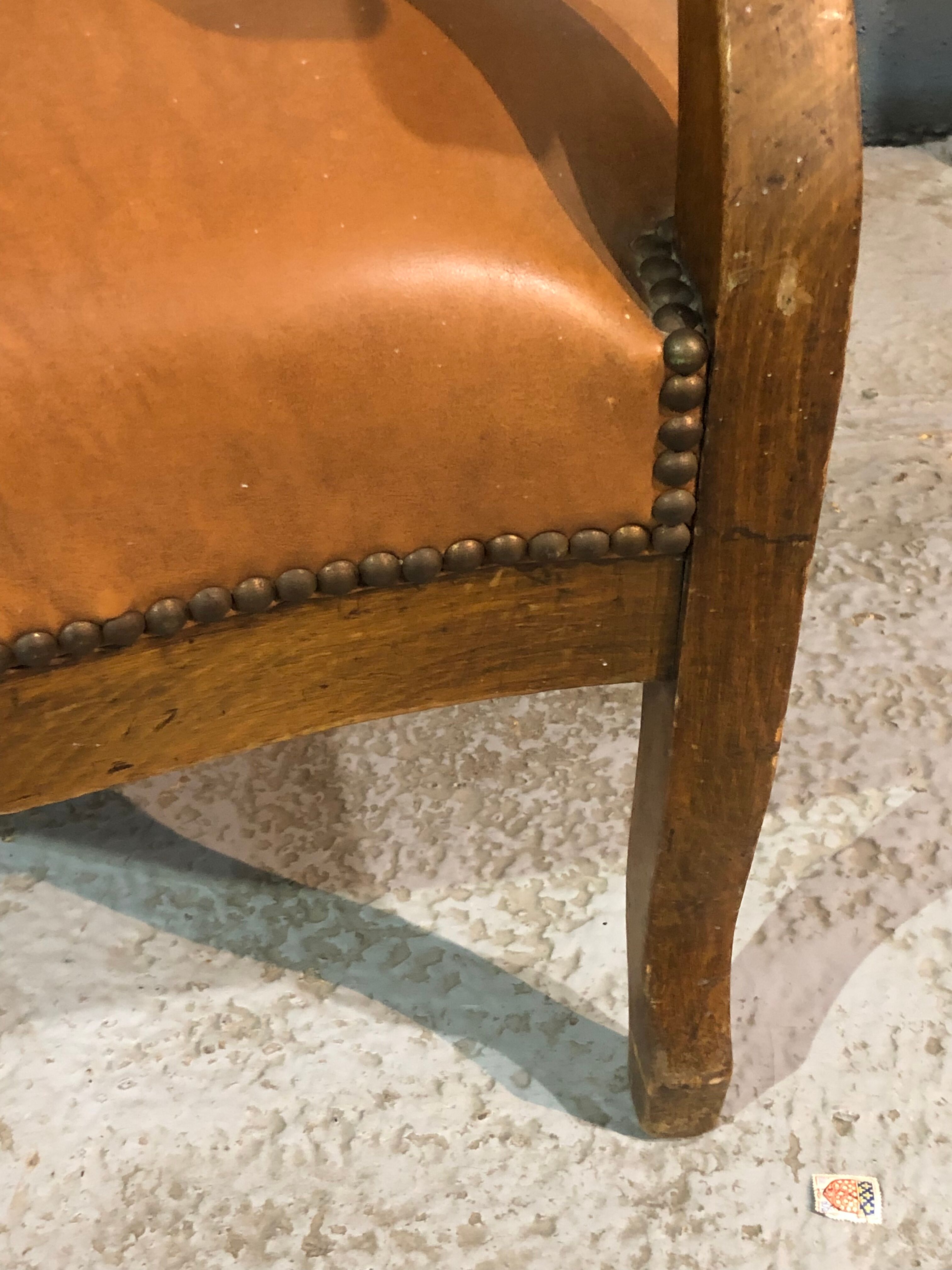 Old Voltaire armchair in light brown leather
