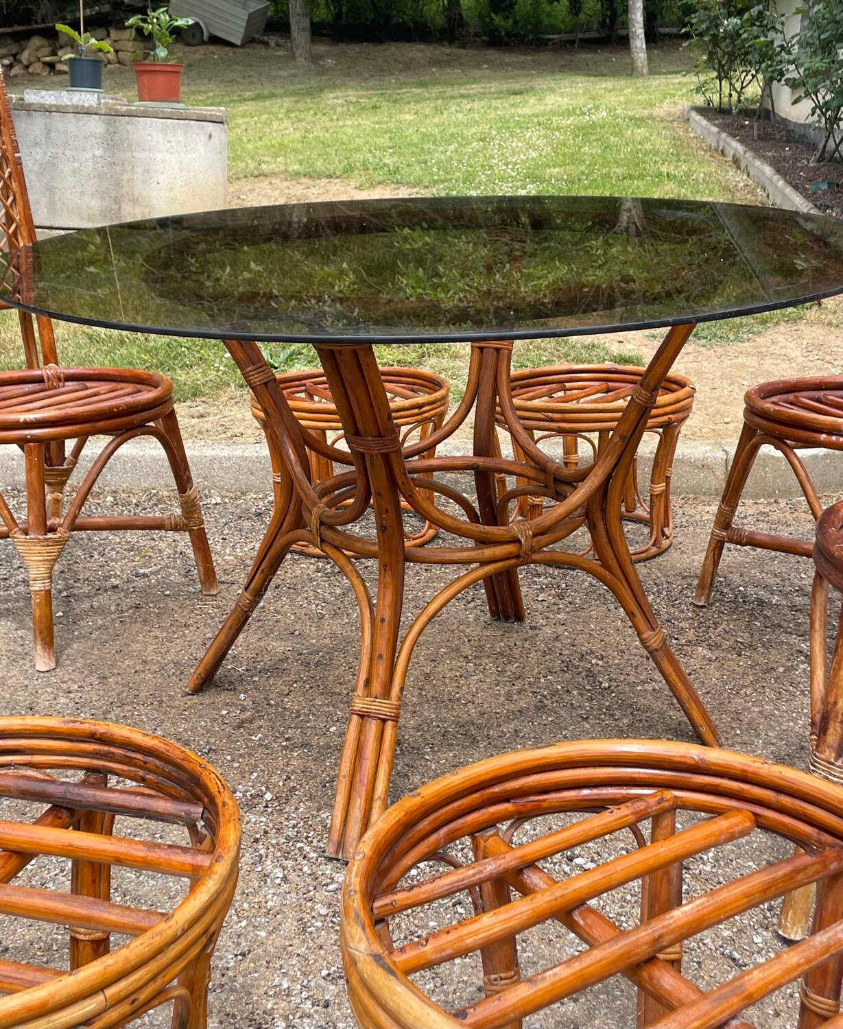 Vintage rattan dining set with glass table, 4 chairs and 4 stools.