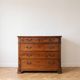 Antique solid wood chest of drawers with four drawers.