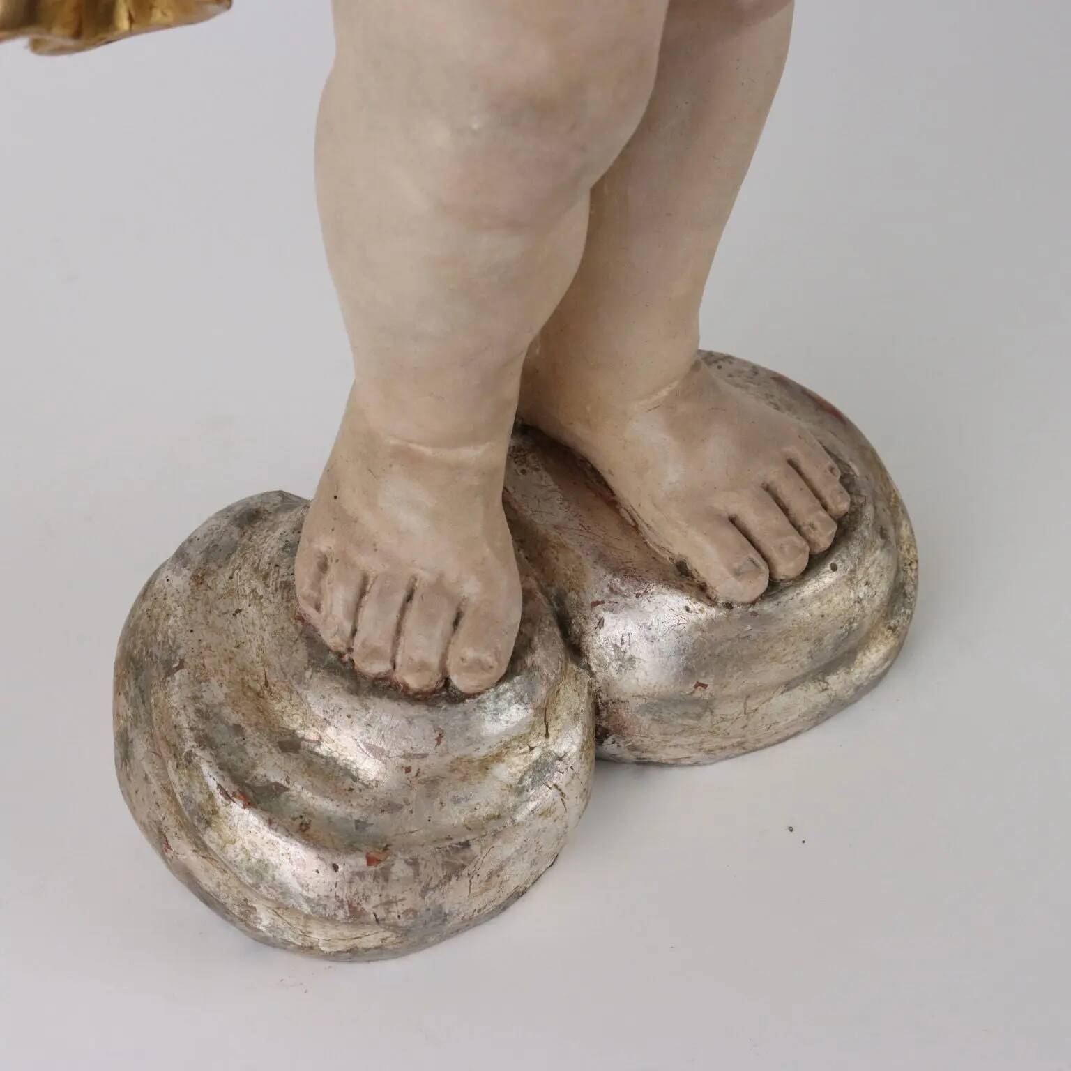 Ancient sculpture of a putto in carved and gilded wood, Italy, 19th century.