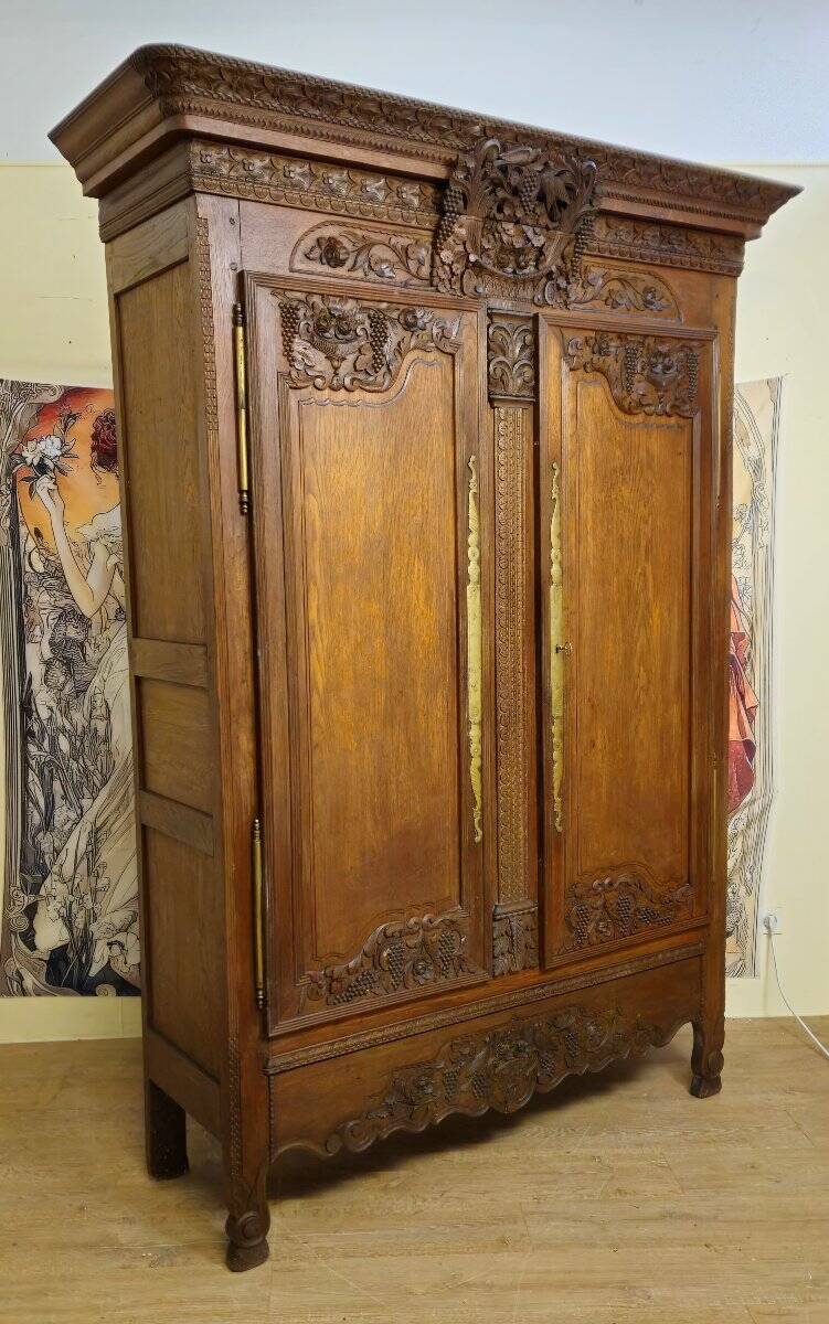 Norman Wedding Armoire in solid oak, richly carved, Louis period.
