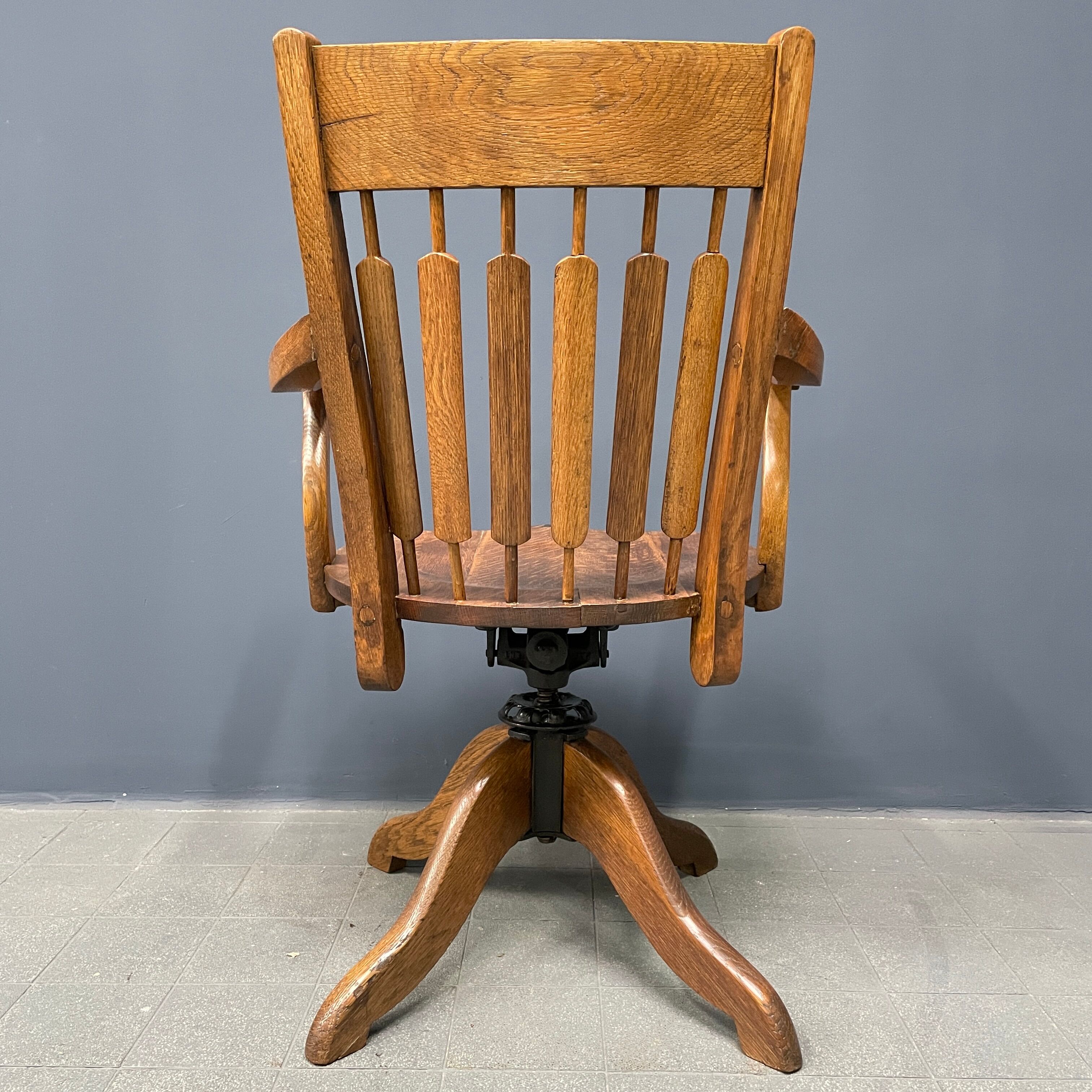 Antique American oak office chair with armrests 1920s
