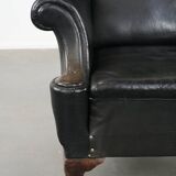 Antique black English cow leather wingback armchair from the 19th century