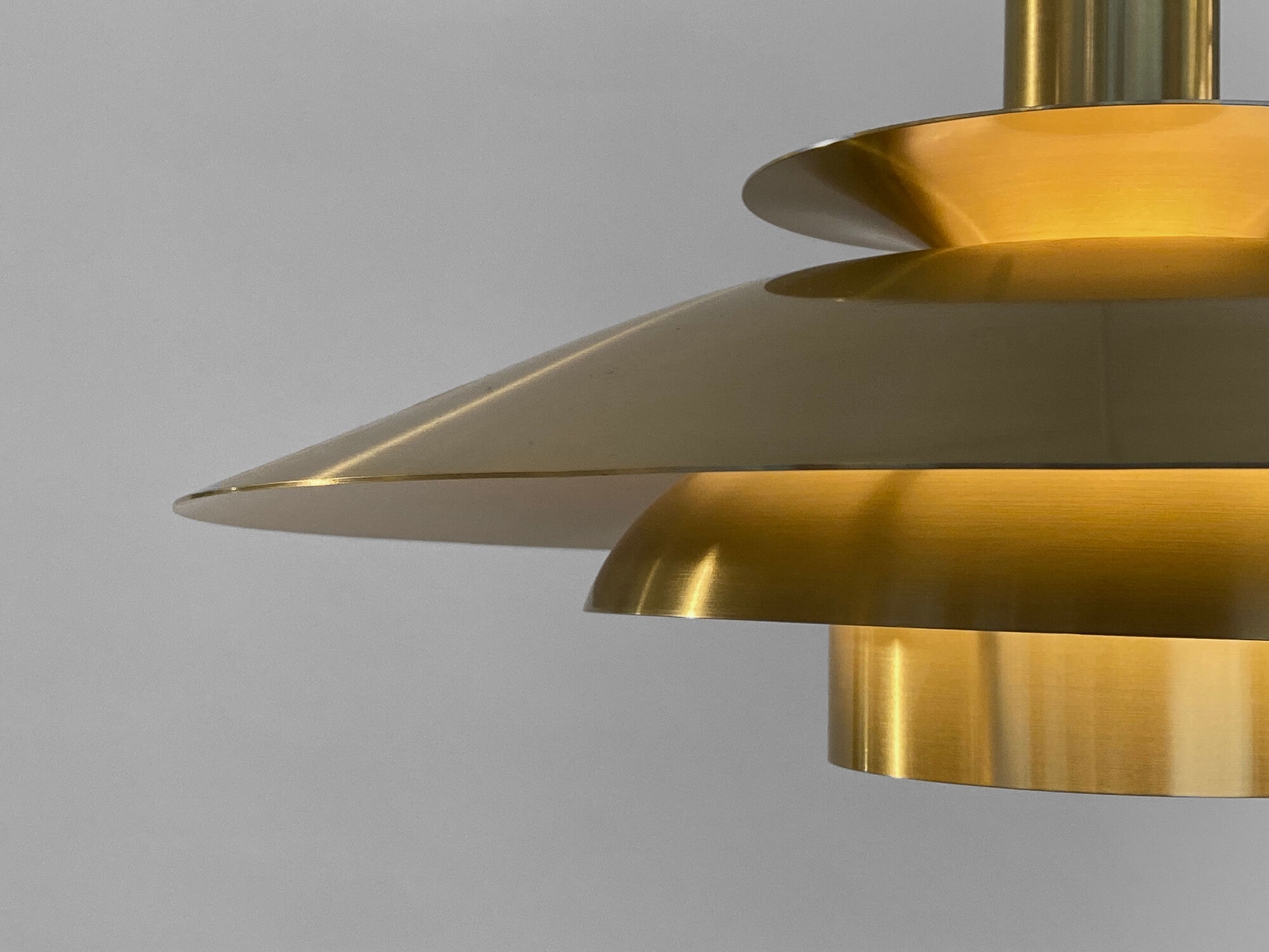 Golden colored aluminum pendant light from Frandsen Lighting. Denmark 1970s