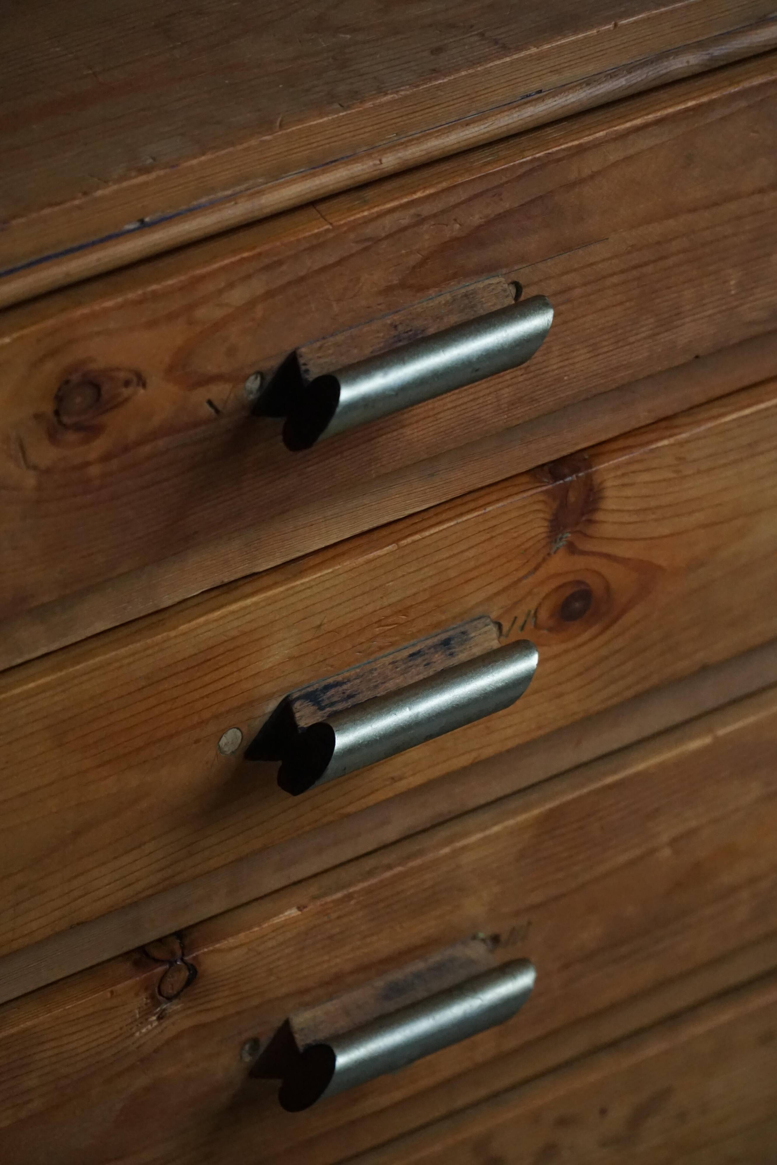 Mid-20th century Art Deco chest of drawers in pine with metal handles, 1940s.