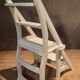 White chair convertible into a staircase.