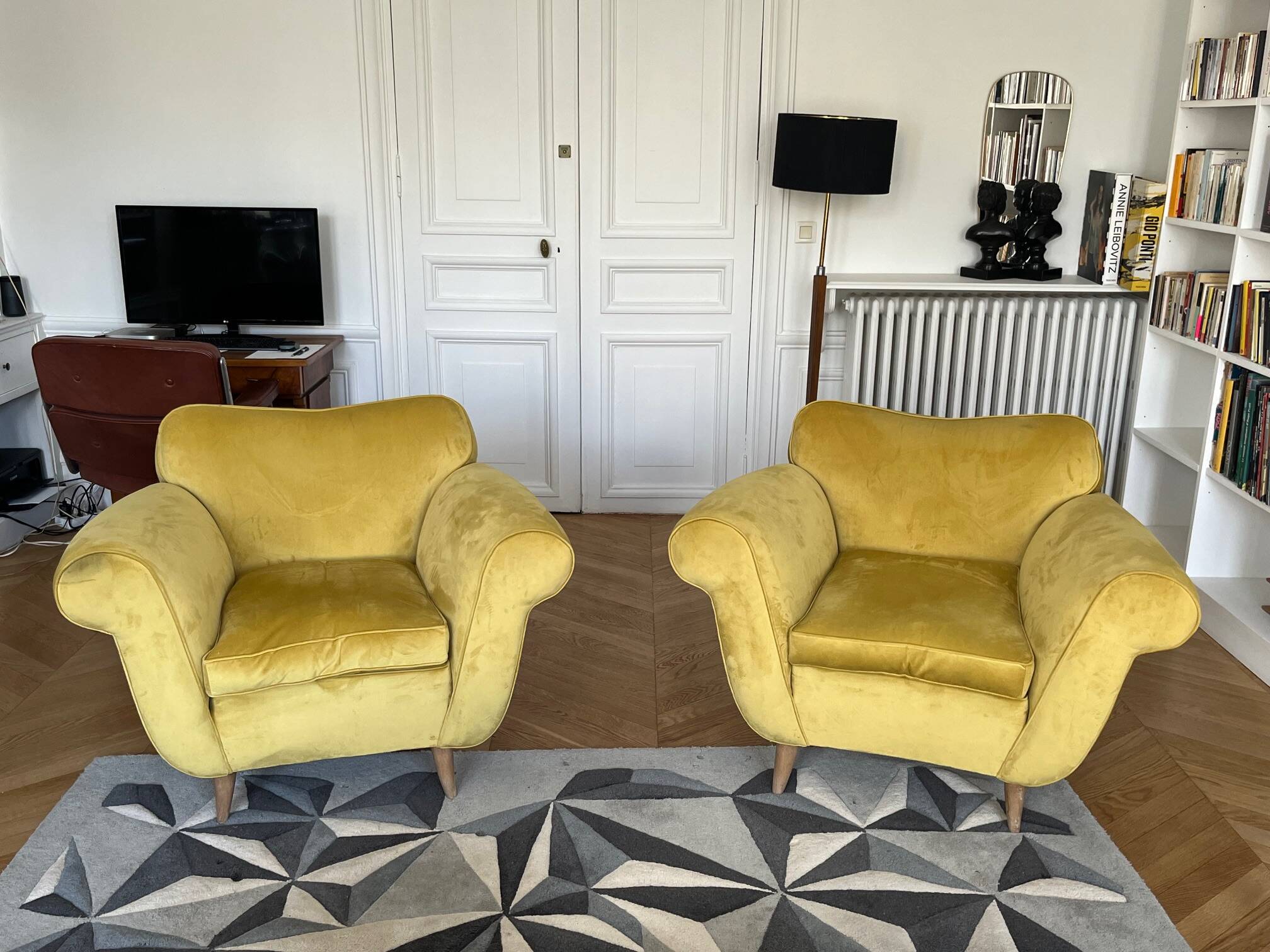 A pair of 1920s armchairs with an ottoman. Good condition.