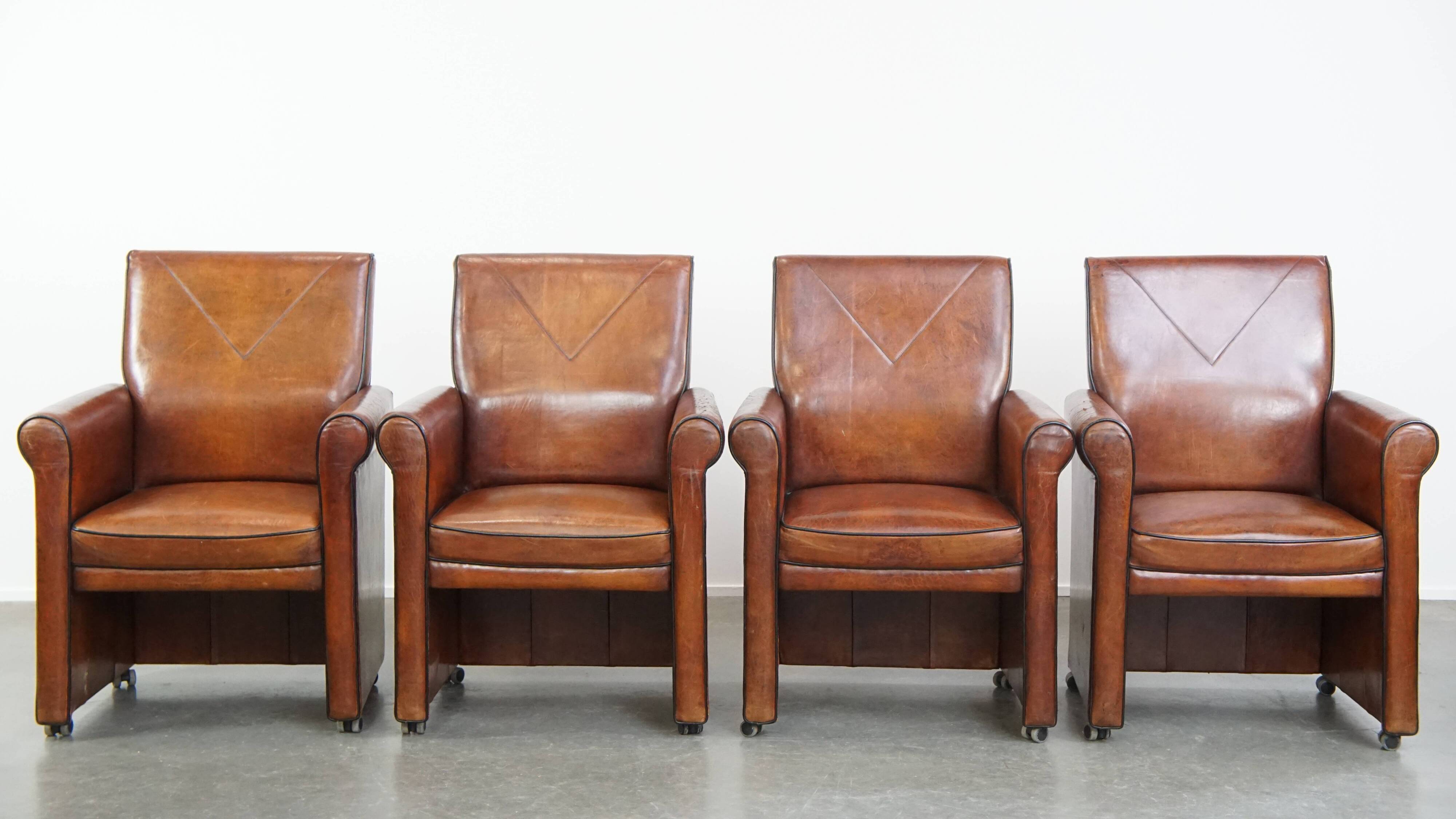 Vintage set of 4 sheepskin leather dining chairs on castors